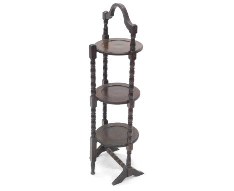 An oak folding three tier cake stand, with bobbin turned supports, 91cm high.  