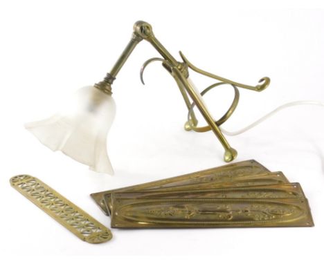 A set of four Edwardian brass finger plates, of rectangular form raised with flowers, 28cm high and a Benson style brass lamp