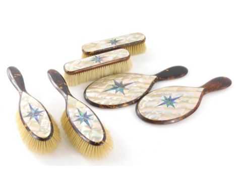 An early 20thC mother of pearl and tortoise shell dressing table set, to include clothes brushes, 15cm wide, hair brushes, an