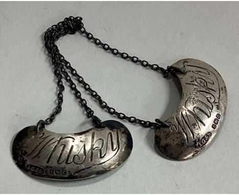 A pair of silver whisky noggin decanter labels. Birmingham. Approx. 4 grams. Est. £40 - £60. 