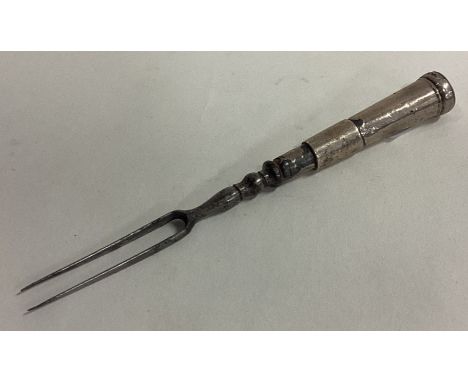 An 18th Century silver two-prong fork. Approx. 15 grams. Est. £60 - £80.