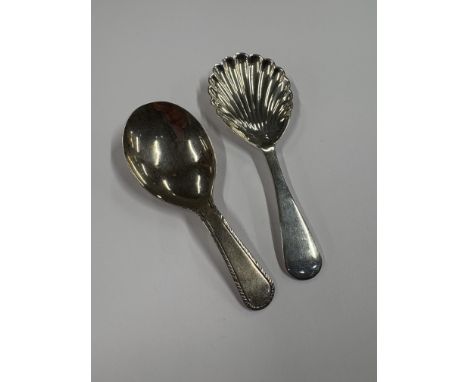 Two silver caddy spoons in the Georgian style. Various dates and makers. Approx. 21 grams. Est. £20 - £30.