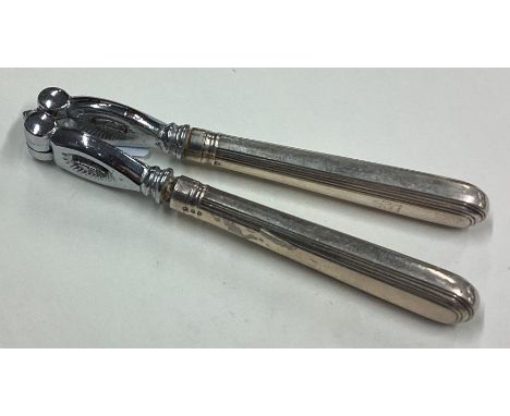 A pair of heavy Georgian silver nutcrackers. By Sebastian Garrard. Approx. 192 grams of gross weight. Est. £80 - £120.