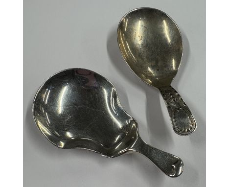 Two silver caddy spoons in the Georgian style. Various dates and makers. Approx. 17 grams. Est. £20 - £30.