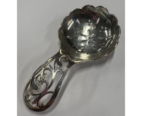 A large silver caddy spoon with pierced decoration in the Georgian style. Birmingham. Approx. 27 grams. Est. £20 - £30.