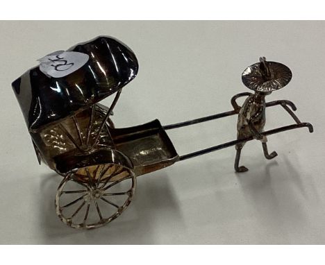 A Chinese silver figure of a man pulling a rickshaw. Approx. 11 grams. Est. £20 - £30.