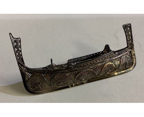 A Chinese silver model of a Longship with filigree decoration. Approx. 21 grams. Est. £30 - £40.