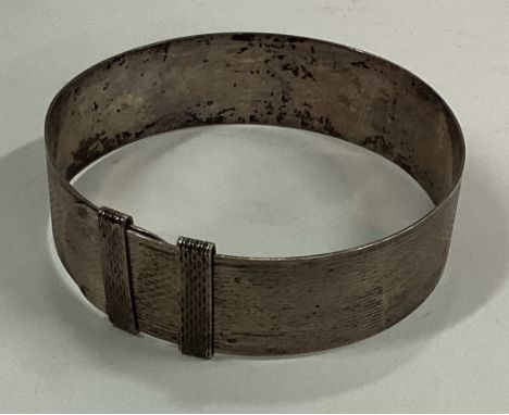 An engine turned silver bangle. Birmingham. Approx. 27 grams. Est. £30 - £40.