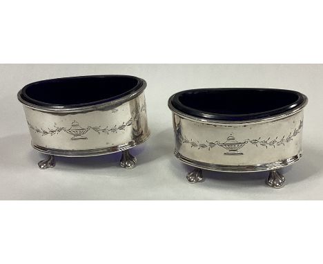 A pair of silver and glass salts decorated with swags. Birmingham 1925. By Adie Brothers. Approx. 90 grams. Est. £40 - £60.