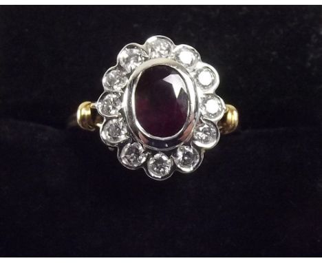 An 18ct gold ruby and diamond oval cluster ring 