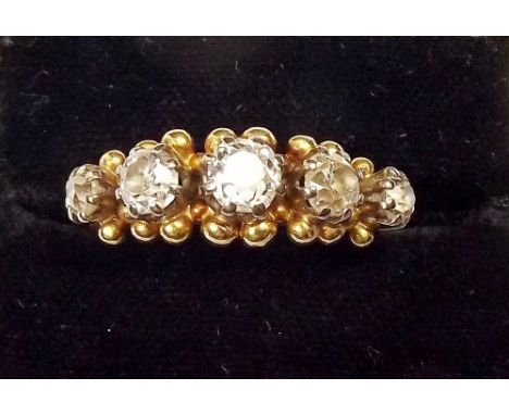 An 18ct gold five stone diamond ring - the cushion cut stones flanked by gold beading, approx total diamond value 1.3 metric 