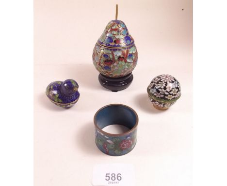 A cloisonne pear on stand together with cloisonne napkin ring and two covered trinket boxes, one in the shape of a bird 