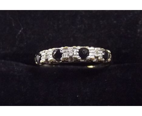 A 9 carat gold sapphire and chip diamond ring