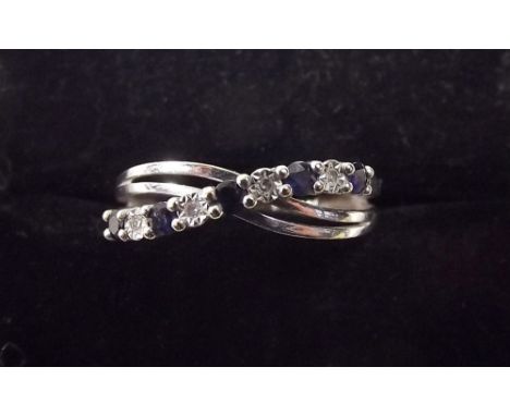 A 9ct white gold sapphire and chip diamond crossover ring 