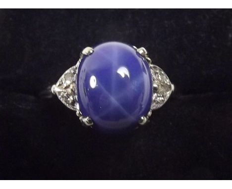 A 14k white gold cabochon cut star sapphire ring 