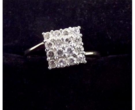 A 9ct gold square panel ring set sixteen diamonds on asymmetrical band 