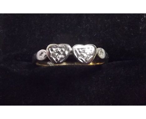 An 18ct gold double heart form ring set two diamonds 