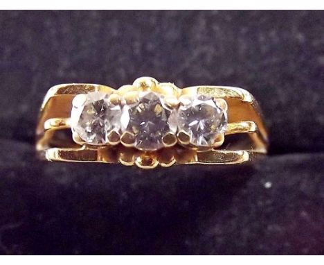 A gold ring set three diamonds on triple split band - unmarked 