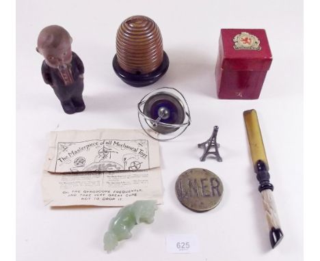 A group of collectables including composition kewpie boy and LNER brass plaque