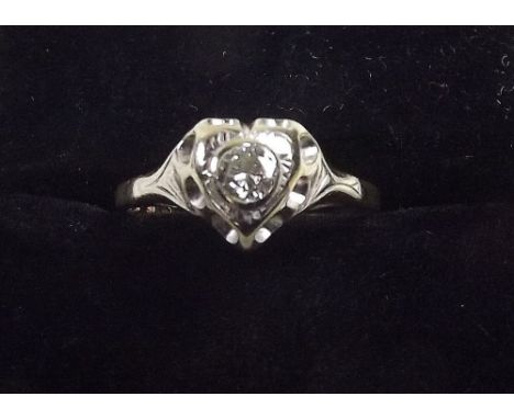 An 18ct gold heart form solitaire diamond ring 