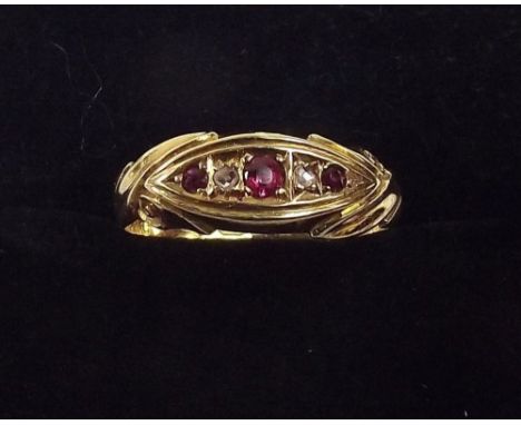 An 18ct gold ring set rubies and chip diamond 