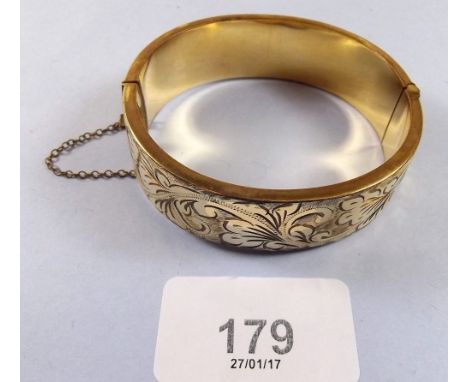 A rolled gold hinged bangle 