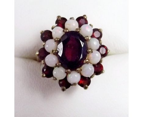 A 9 carat gold ring set garnets and opals