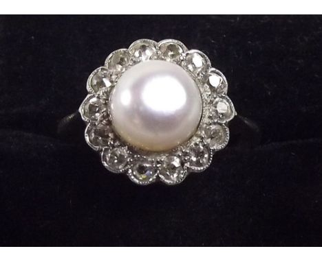 An 18ct gold ring set untested pearl within diamond surround 