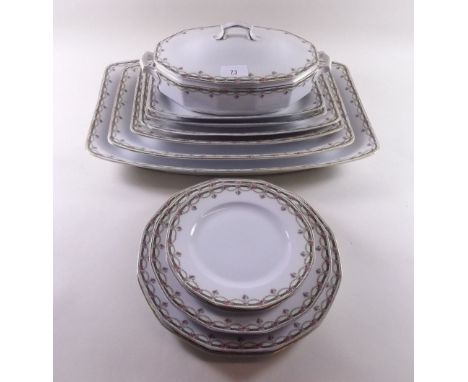 A porcelain dinner service printed swags of roses comprising: six graduated meat plates, tureen, eleven dinner plates, six de