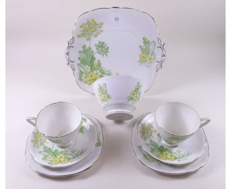 A bone china part tea service printed primroses comprising, five cups and saucers, five tea plates, a cake plate and a sugar 