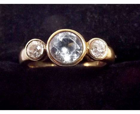 An 18ct gold ring set a blue zircon flanked by a pair of diamonds 