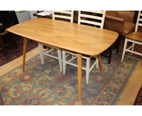 An Ercol elm topped dining table, raised on beech legs, 72cm high, 153cm wide, 75cm deep