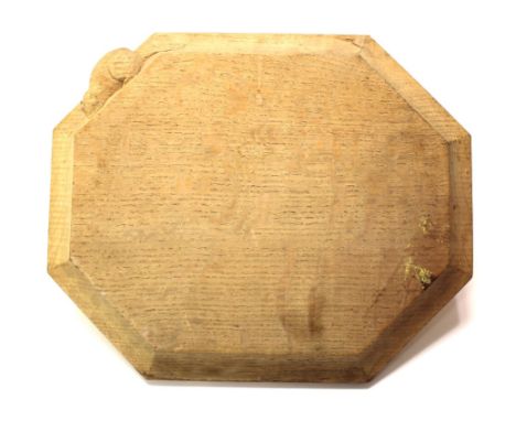 Robert 'Mouseman' Thompson of Kilburn, an Arts and Crafts oak bread board, octagonal form, 30.5cm by 25cm approx; together wi