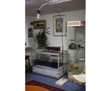 After Harvey Guzzini, a chrome and marble floor lamp, circa 1960s, arched form, lacking shade