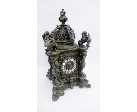 Bronze patinated metal mantle clock with coronet top, lion finials and cherub uprights, 45cm high 