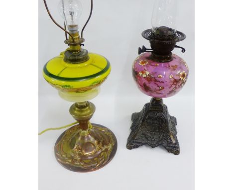 Two oil lamp bases, one converted to electricity, both with coloured glass wells 