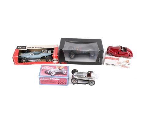 A collection of Schuco clockwork vehicles. Including a boxed 'Classic' in metallic black, boxed 1072 BMW Formula 2, an Examic