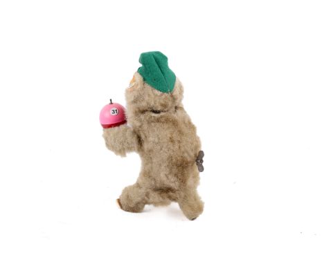A Lustige Urwald Musik clockwork Jolly Monkey. The artificial plush covered monkey with a permanent key, holding pink and red