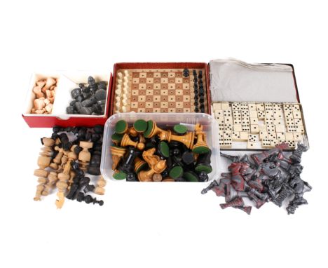 Five vintage chess sets and a set of bone dominoes. The chess sets including three wooden sets (one in a Staunton Chess box),