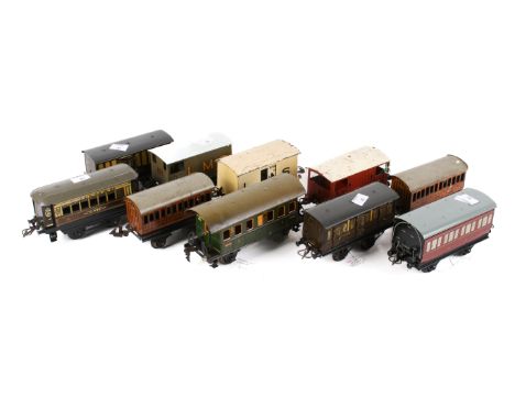 An assortment of circa 1930s O gauge carriages and wagons. Including a Hornby LMS Refrigerator Van and a Marklin Coach, etc. 