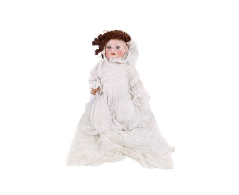 A Simon &amp; Halbig doll. Having a bisque porcelain head, painted features, blue glass blinking eyes and a brown wig, marked