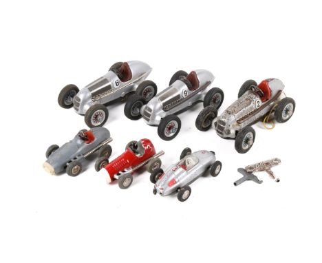 Six Schuco tinplate clockwork racing cars. Comprising three 1050 Schuco Studio Rennwagen, a 1043 Micro Racer, a 1042 Micro Ra