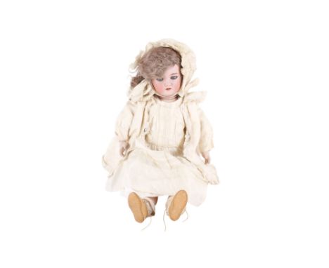 A Simon & Halbig bisque headed doll. Numbered '8', having blue blinking eyes, painted features and an open mouth with teeth, 