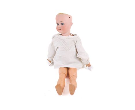 A Simon & Halbig doll. Having a bisque porcelain head, painted features, blue glass eyes and a brown wig, marked 'S H 1909 5 