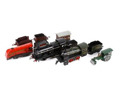 An assortment of early 20th century German and British 0 gauge clockwork toys. Including a Bing loco 3830, Bassett Lowke loco