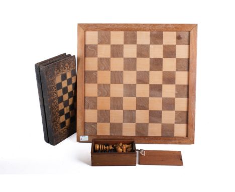 A vintage chess board with pieces and a papier mache games box. The wooden chessboard 41cm x 41cm, the pieces in a sliding bo