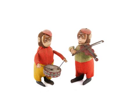 Two German Schuco wind-up musician monkeys. One playing a violin, the other a drum