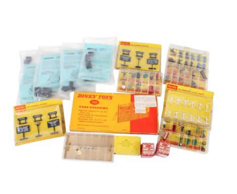 An assortment of train layout accessories. Including a Dinky 765 Road Hoarding, boxed Dinky Toys 050 Railway Staff, two054 Ra