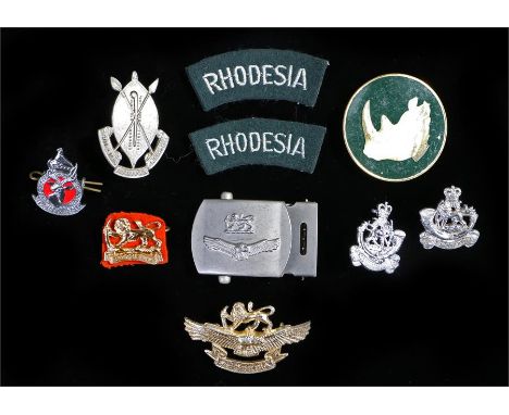 1970s Rhodesian armed forces badges, including; Rhodesian Forces cap badge and belt buckle, Rhodesian Light Infantry beret ba