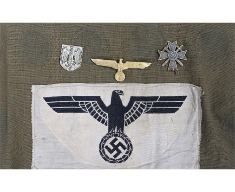 World War II German Third Reich sports shirt fabric with eagle badge and swastika sewn on, together with a helmet badge, wing